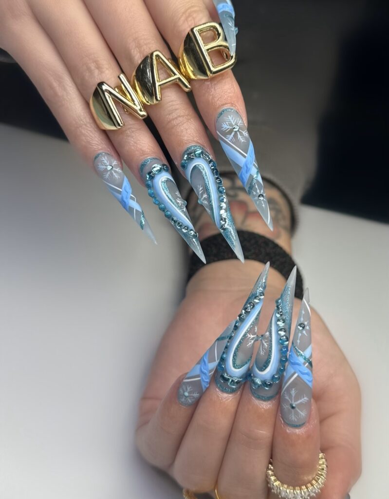 Elegant acrylic nails with glossy finish and detailed nail art, created at a professional nail salon in Las Vegas, showcasing long-lasting and stylish designs